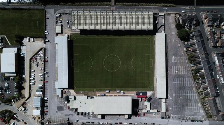 aerial view of vacant football stadium venue for article about sports and the stock market.